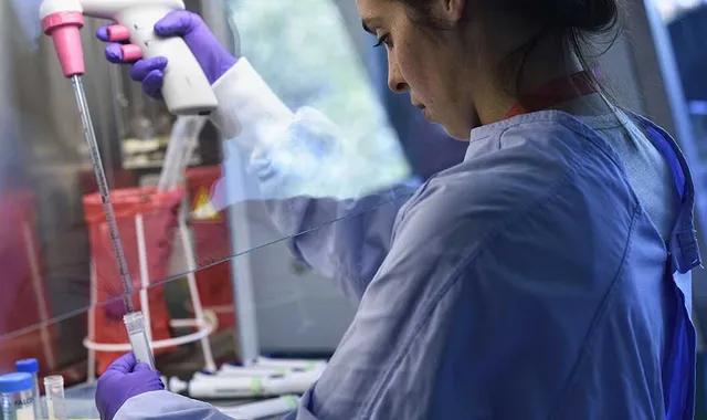 Une scientifique étudie les cellules tumorales dans un laboratoire.